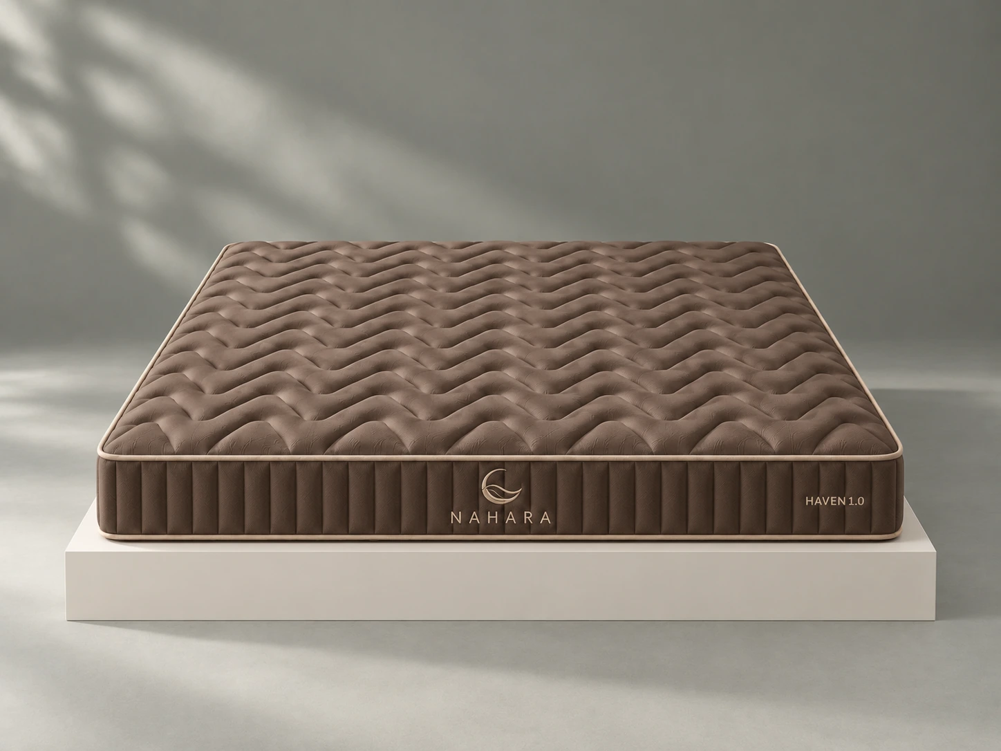 Coffee brown HAVEN 1.0 mattress viewed from the front on a minimal studio plinth