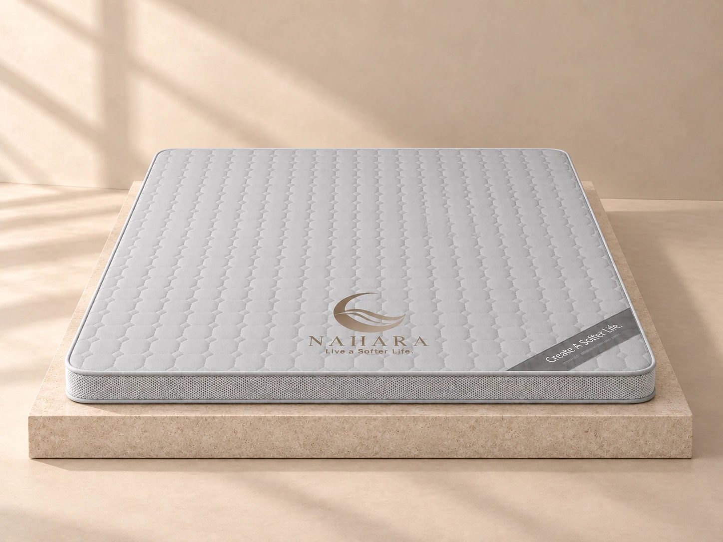Grey NEST 1.0 mattress viewed from the front on a limestone studio plinth